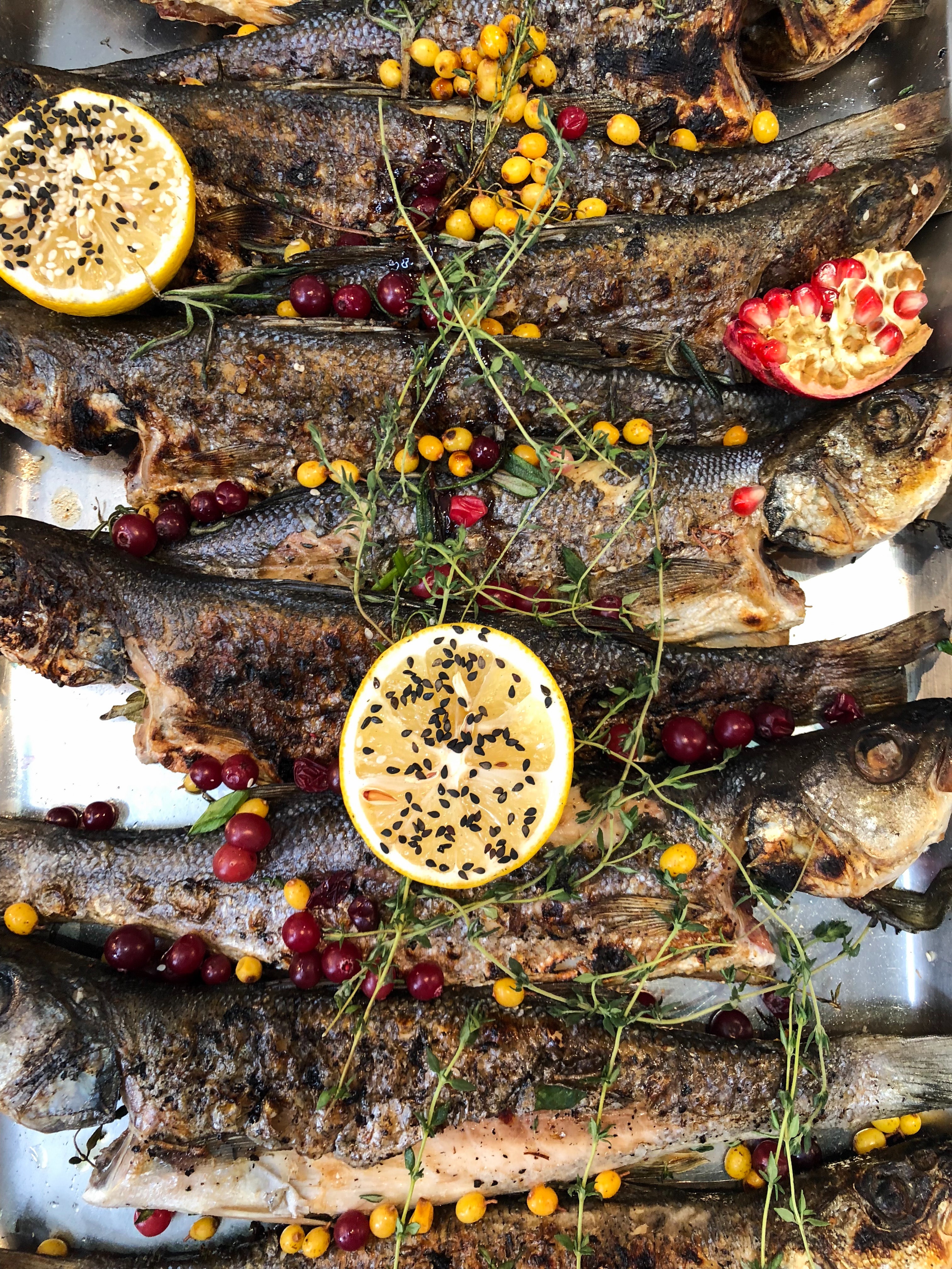 marinated fish feast of fish at Christmas Eve dinner Italy Italian tradition herbs lemon tray seasoning 