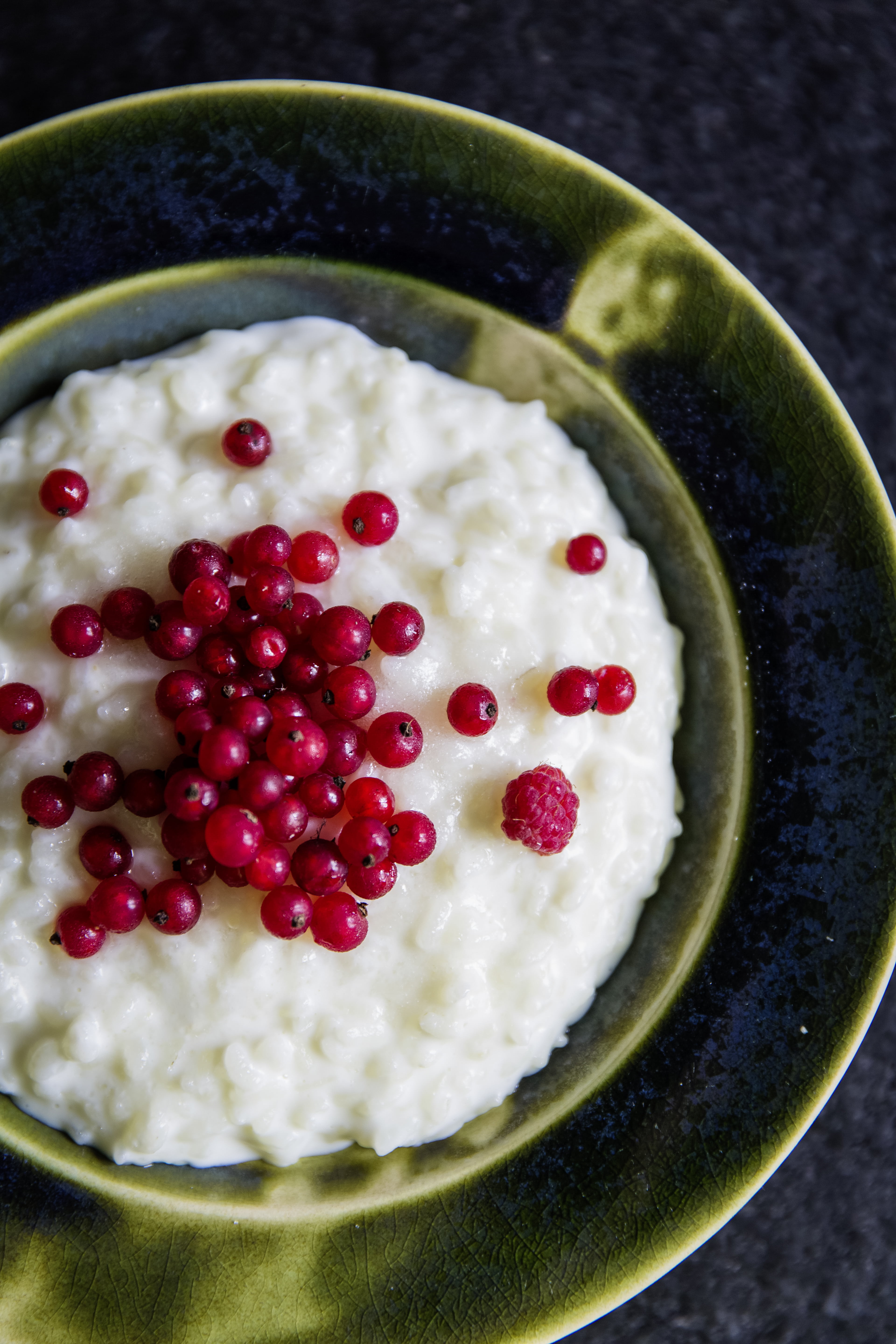 rice pudding porridge berries Christmas tradition hidden almond Europe milk berries red bowl